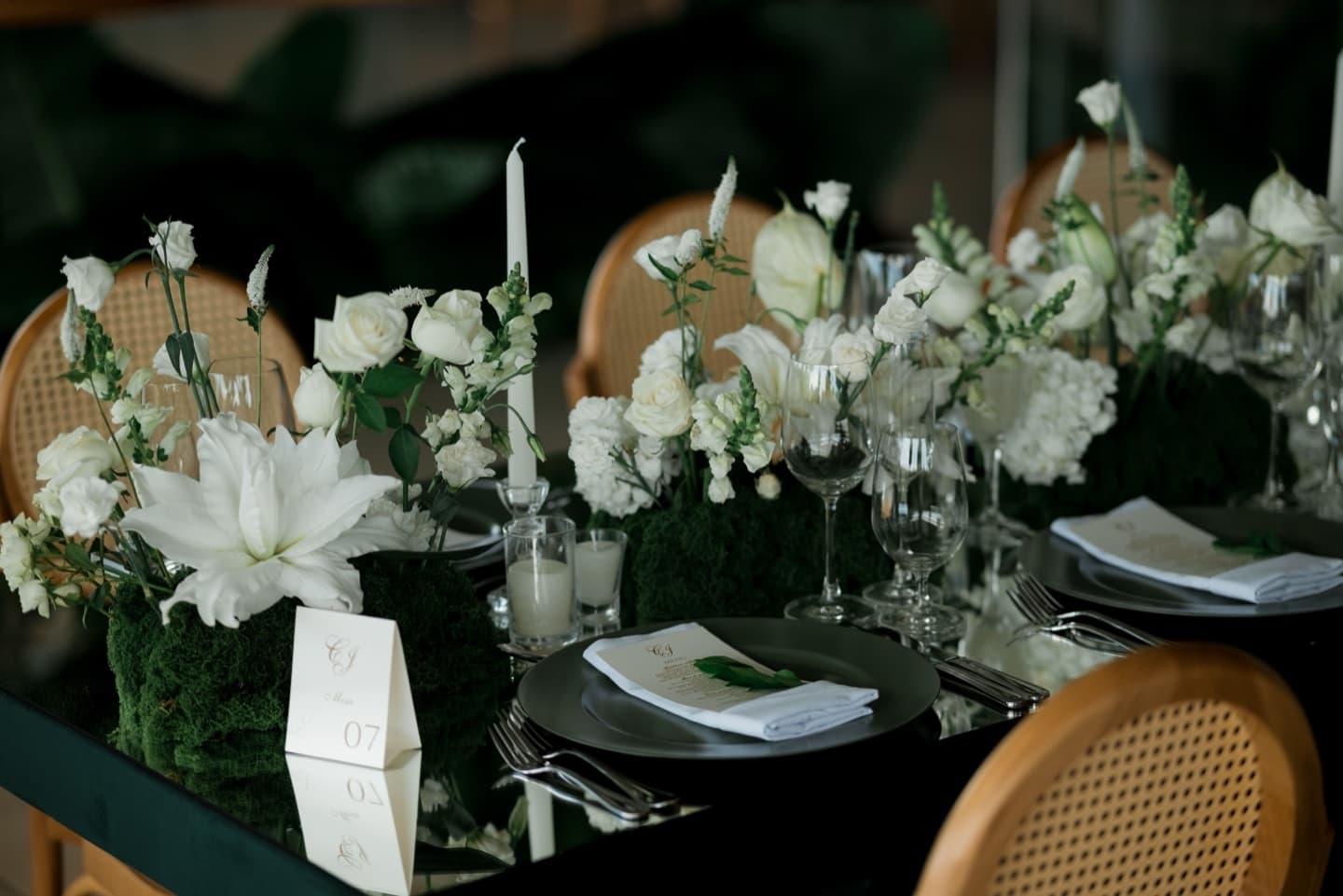Stock photograph of an elegant reception table with white flowers and place settings