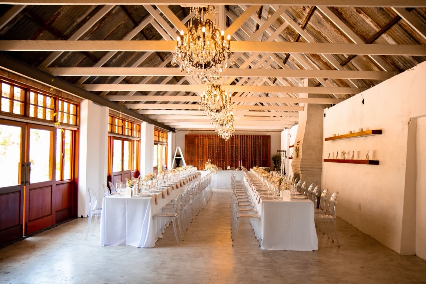 Stock photograph of an elegant reception room with chandeliers and long dining tables