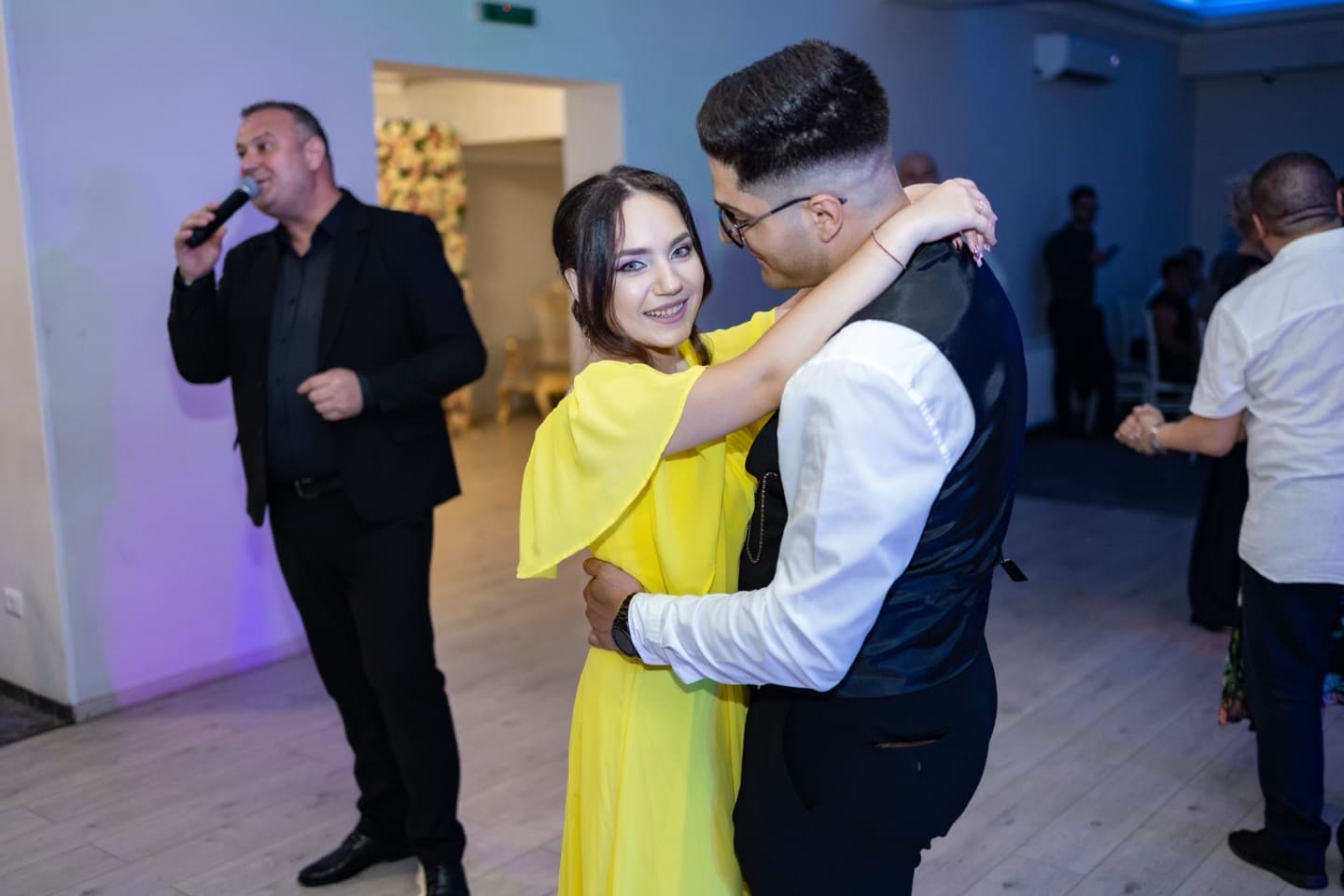 Stock photograph of a couple dancing together during an indoor reception